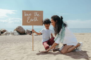 child and parent cleaning beach